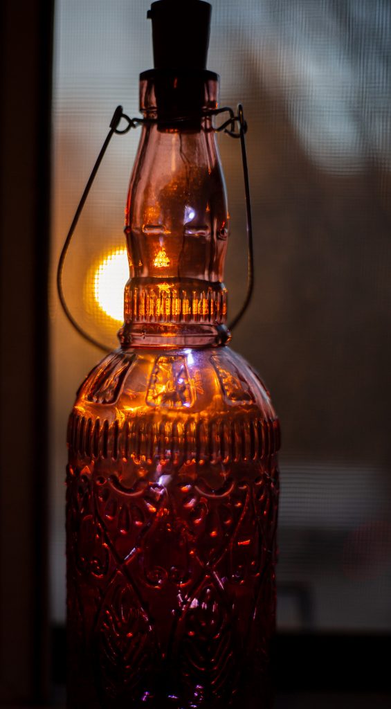 Bottle with sunset in background