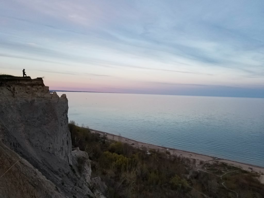 silhouette of person standing on scarborough bluffs